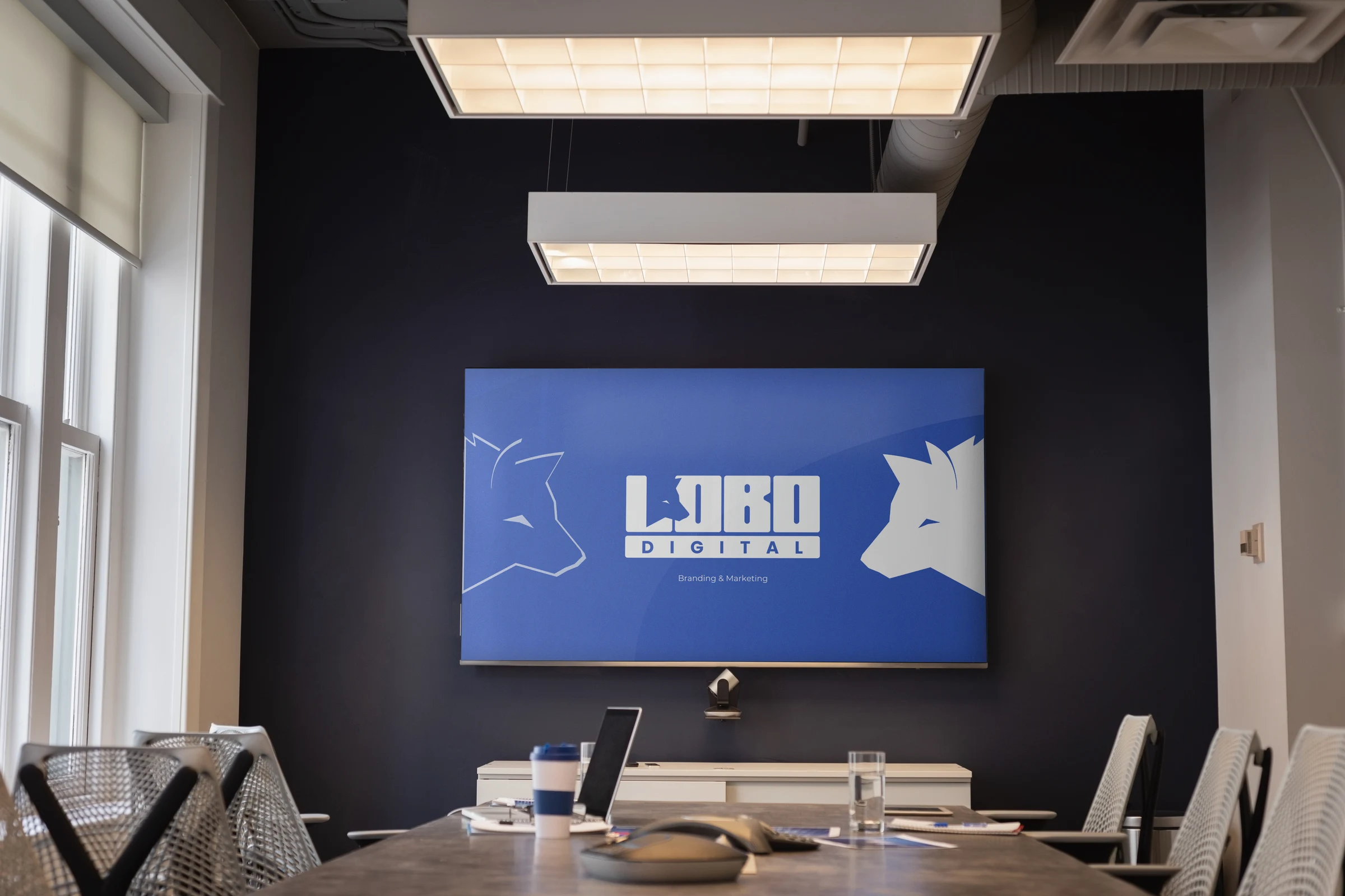 Lobo Digital meeting space with logo on TV screen