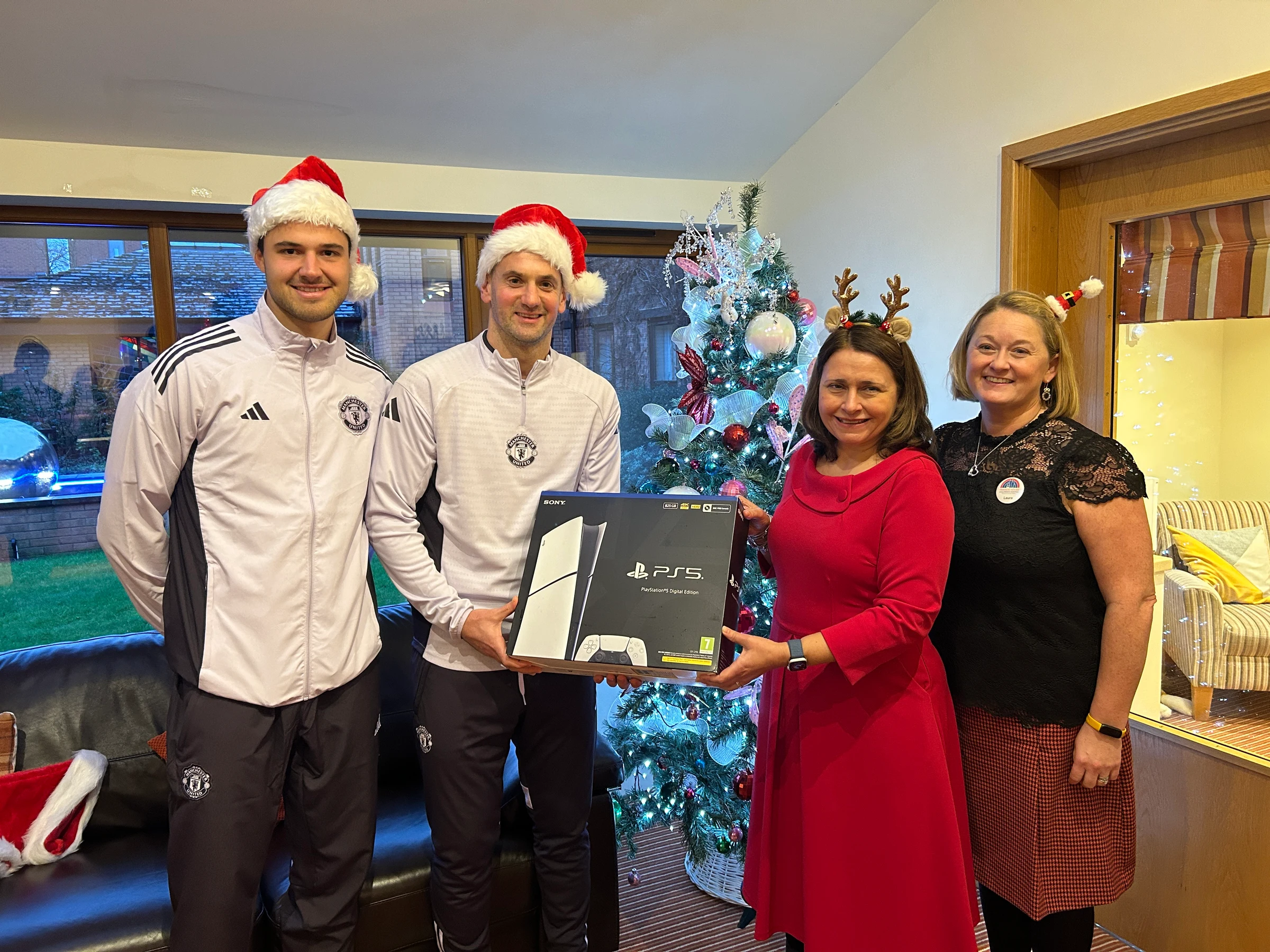 Senne Lammens and Tom Heaton donating a PlayStation to Rachael Taylor, CEO of Francis House and Laura Earley, Clinical Lead of Francis Lodge.