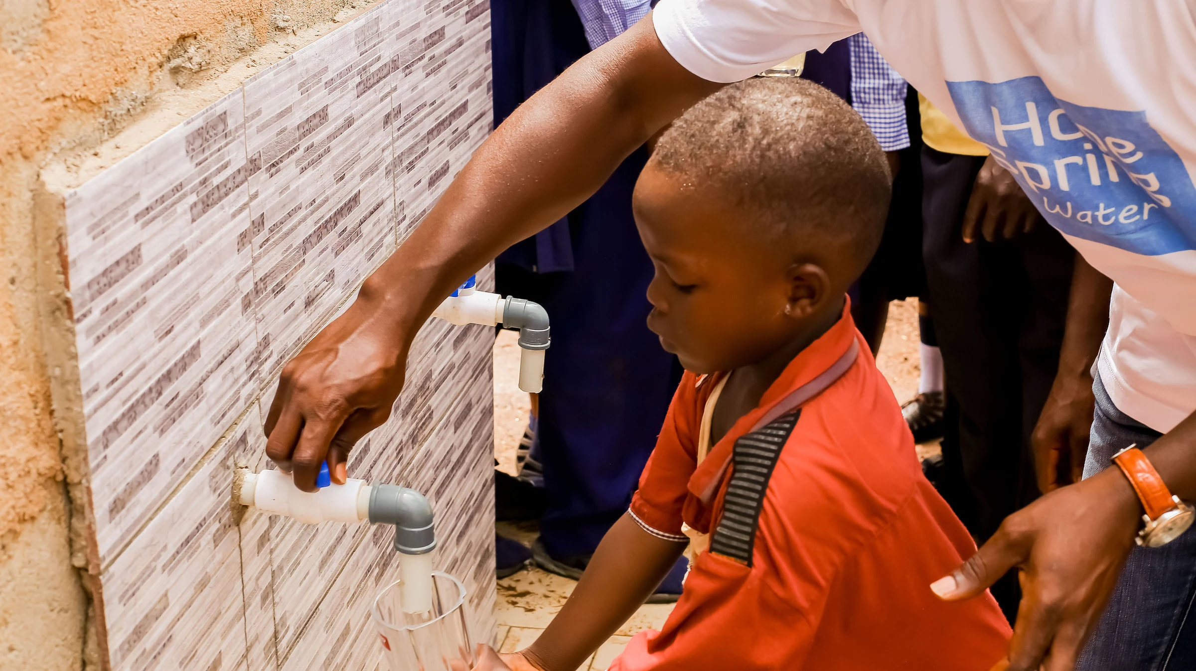 Image showing a child getting water from the newly completed water project
