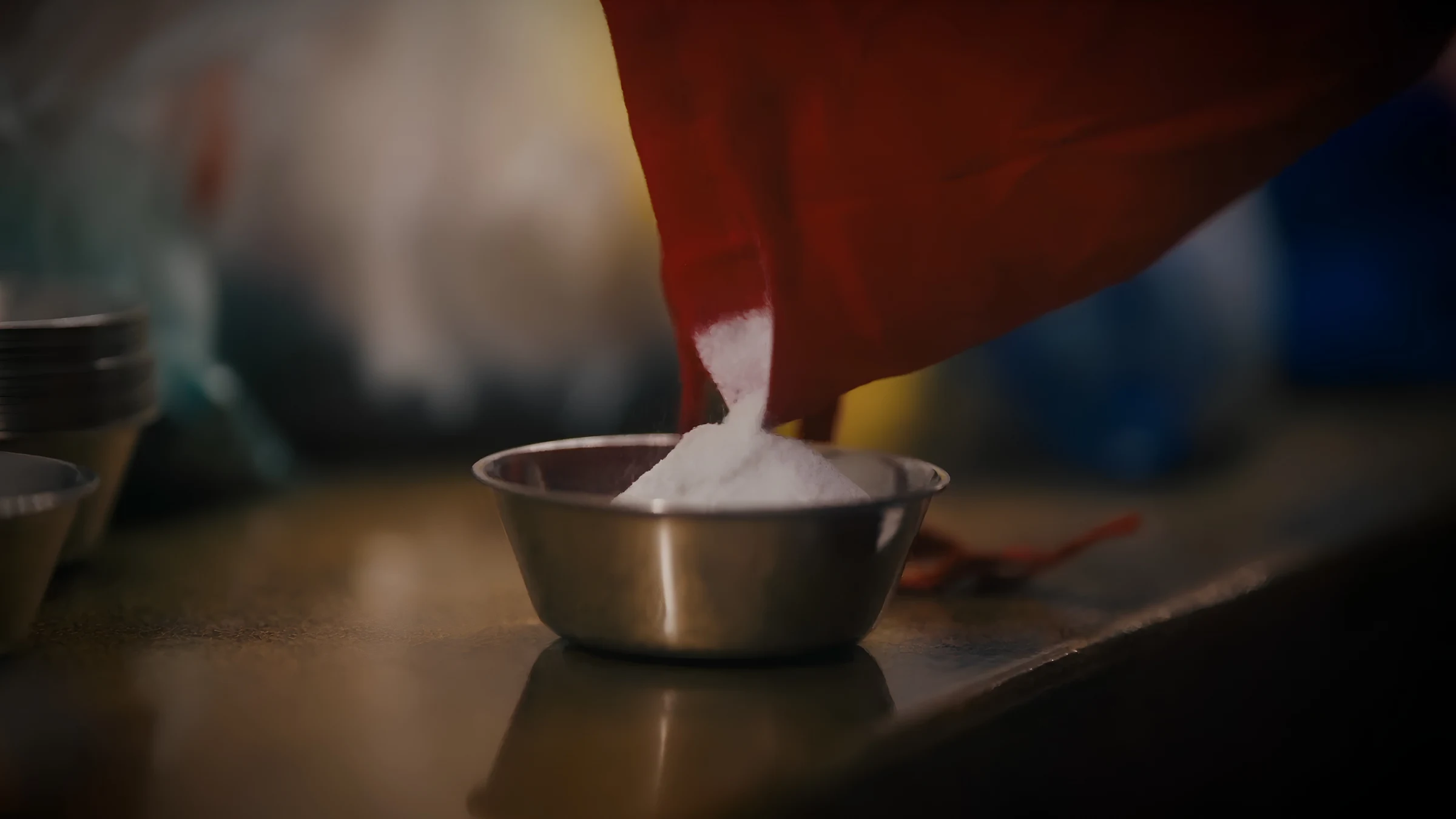 Monk preparing coloured sand for mandala construction