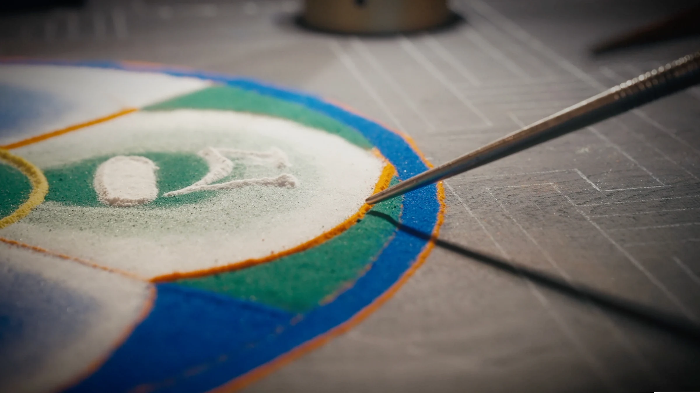 Centre of the sand mandala being completed
