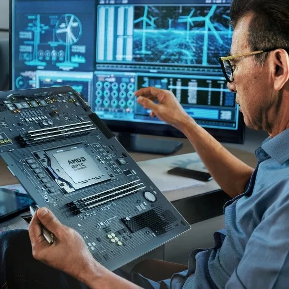 An engineer holding a high-performance motherboard featuring an AMD EPYC