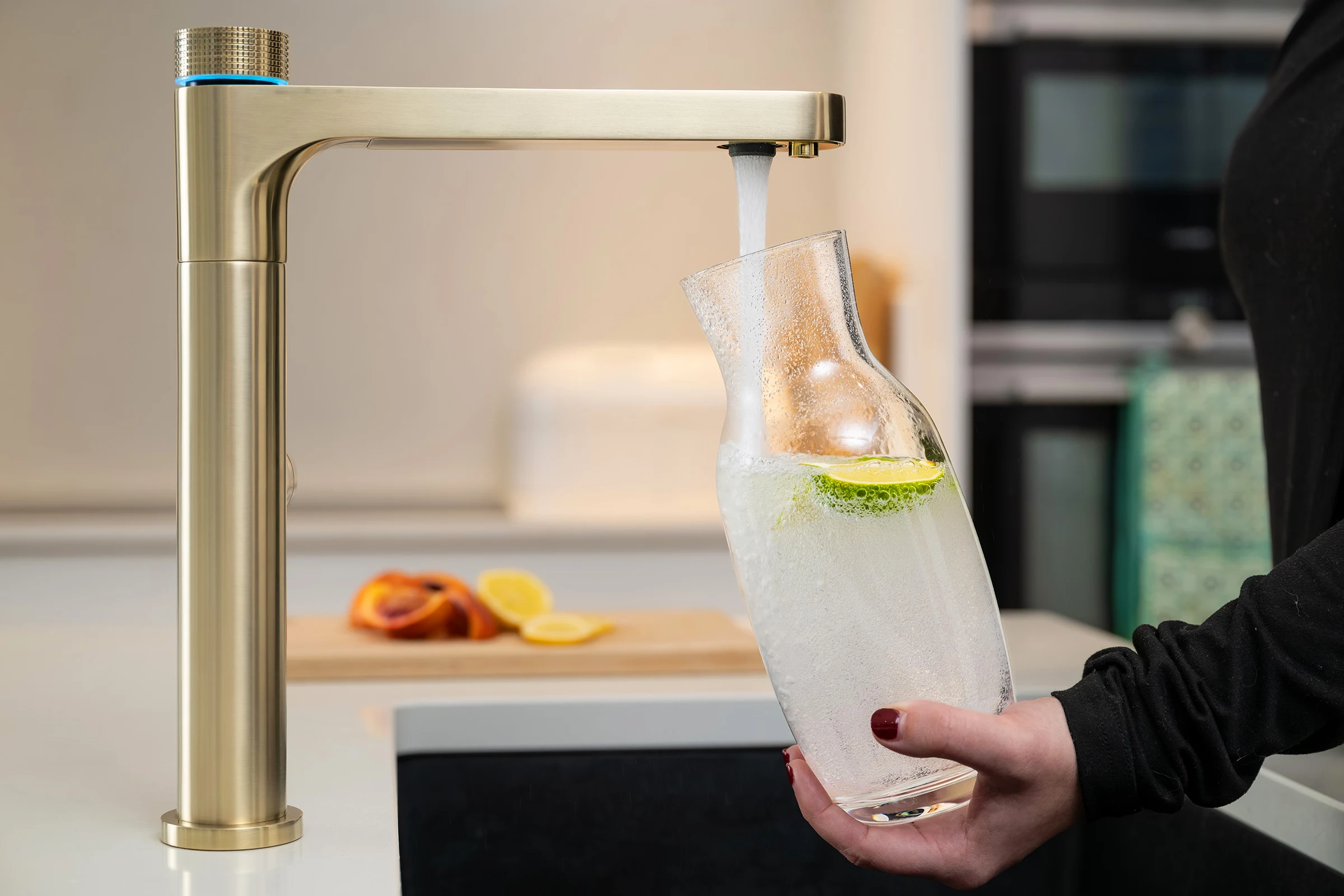 Aquatap Ultimo sparkling water tap dispensing chilled carbonated water into a glass jug