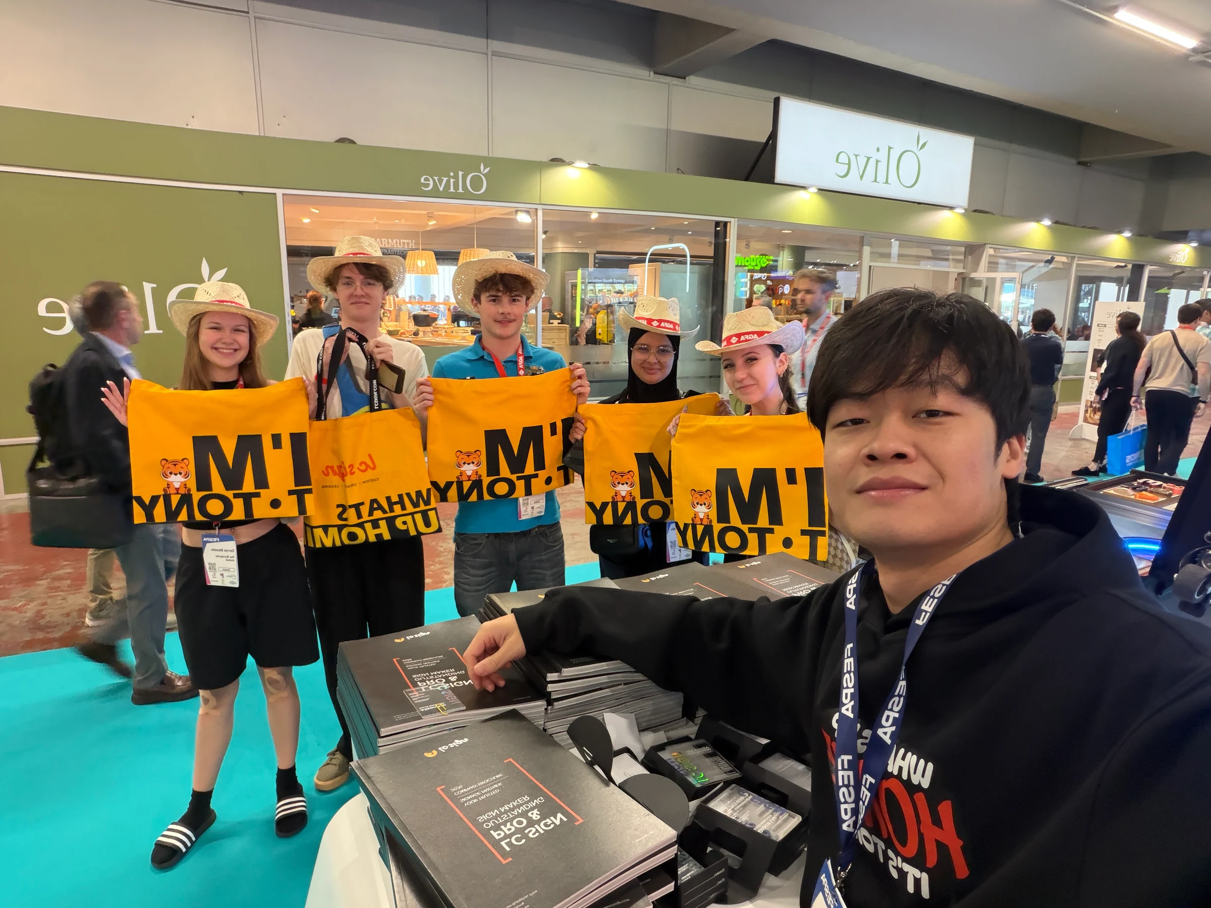 Tony Zhu of LC Sign taking photos with visitors and signage industry professionals during FESPA Global Print Expo 2026 in Barcelona.