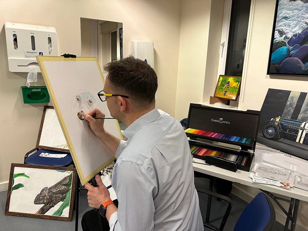 One of the artists at the Pop-Up Art Weekend giving a live demonstration of how he paints his pictures.