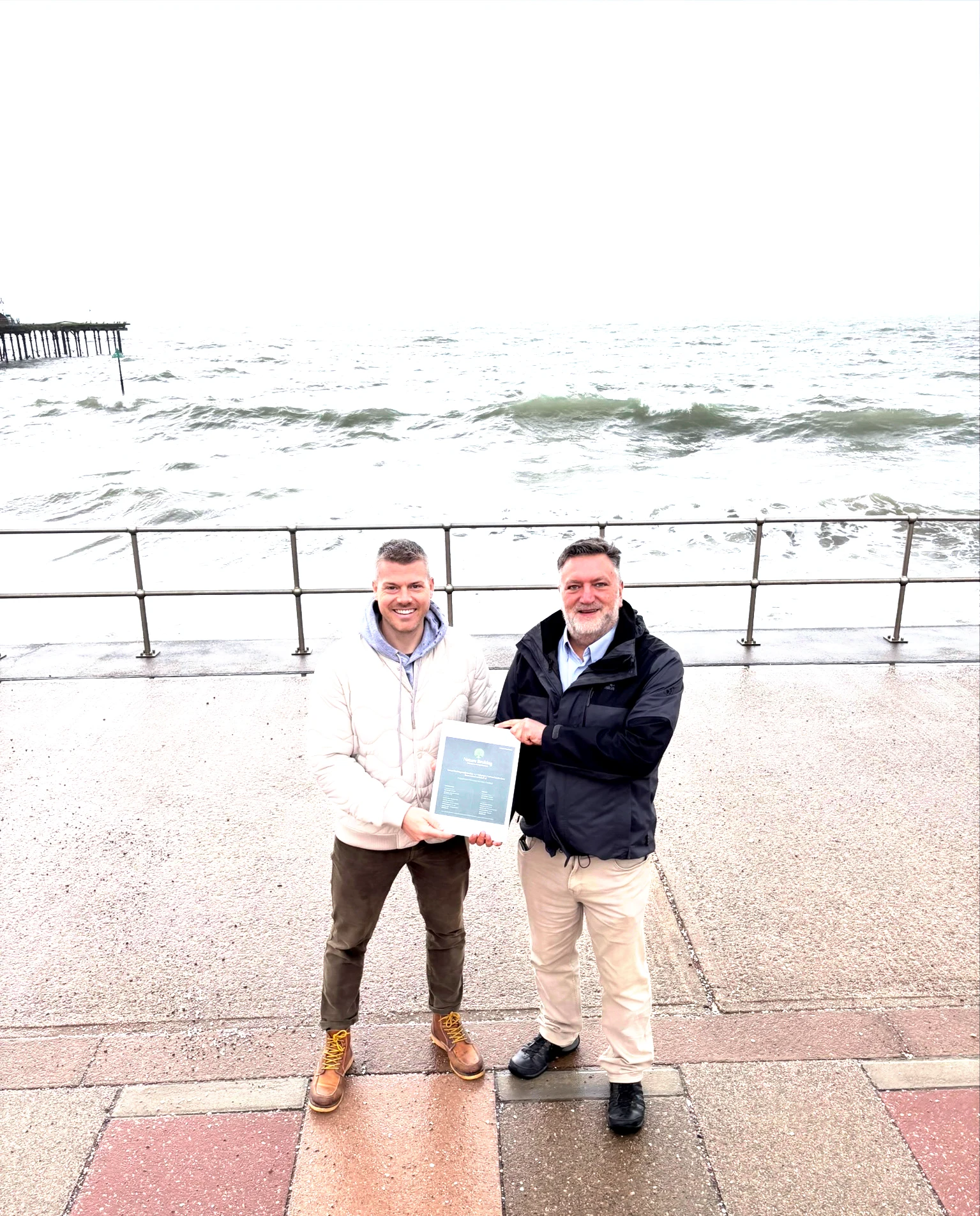 Ashley Webber, Director at Balanced Energy (left) presents Roger Full, Commercial Director at TMS (right), with carbon neutral certification