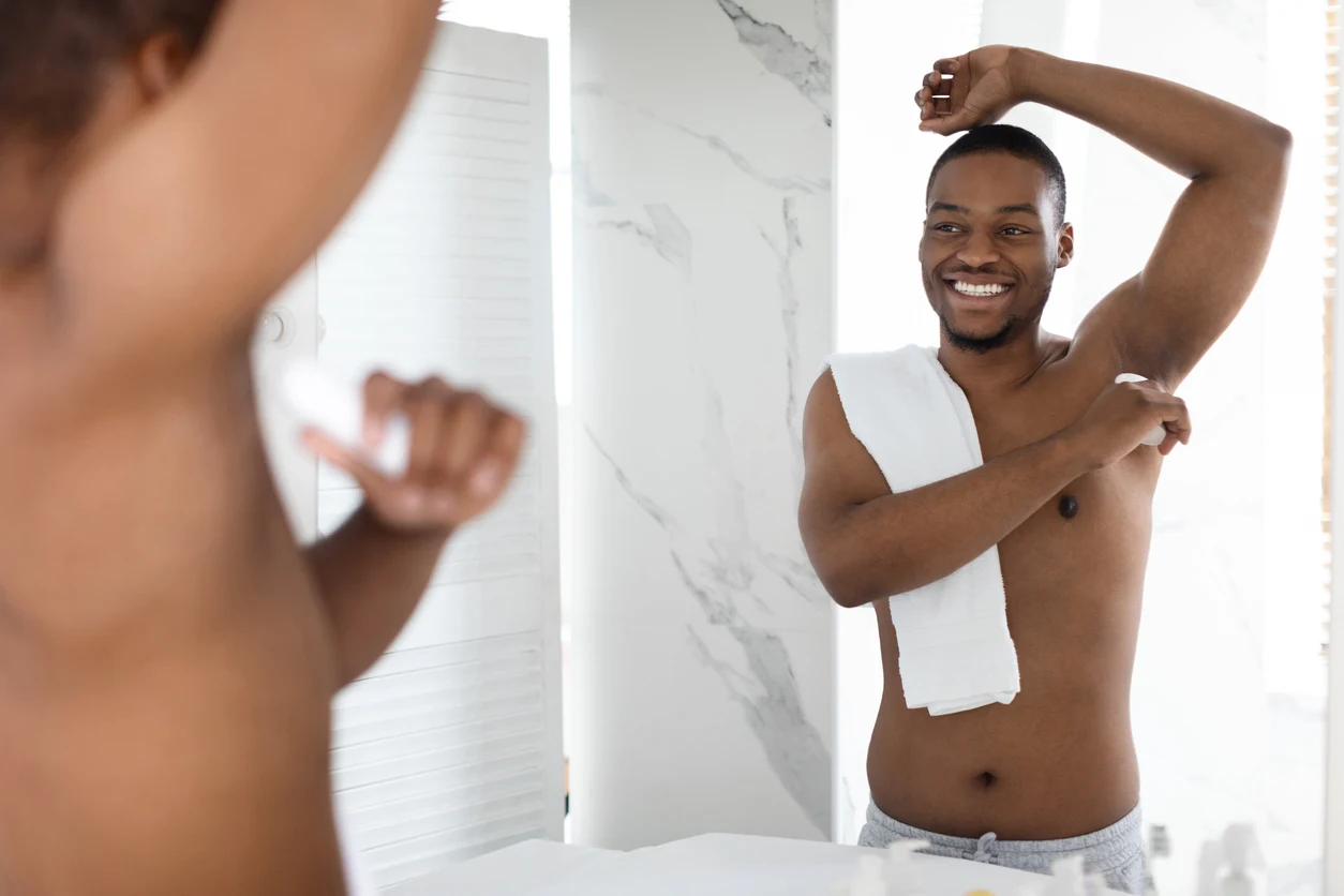 deodorant being applied by a man