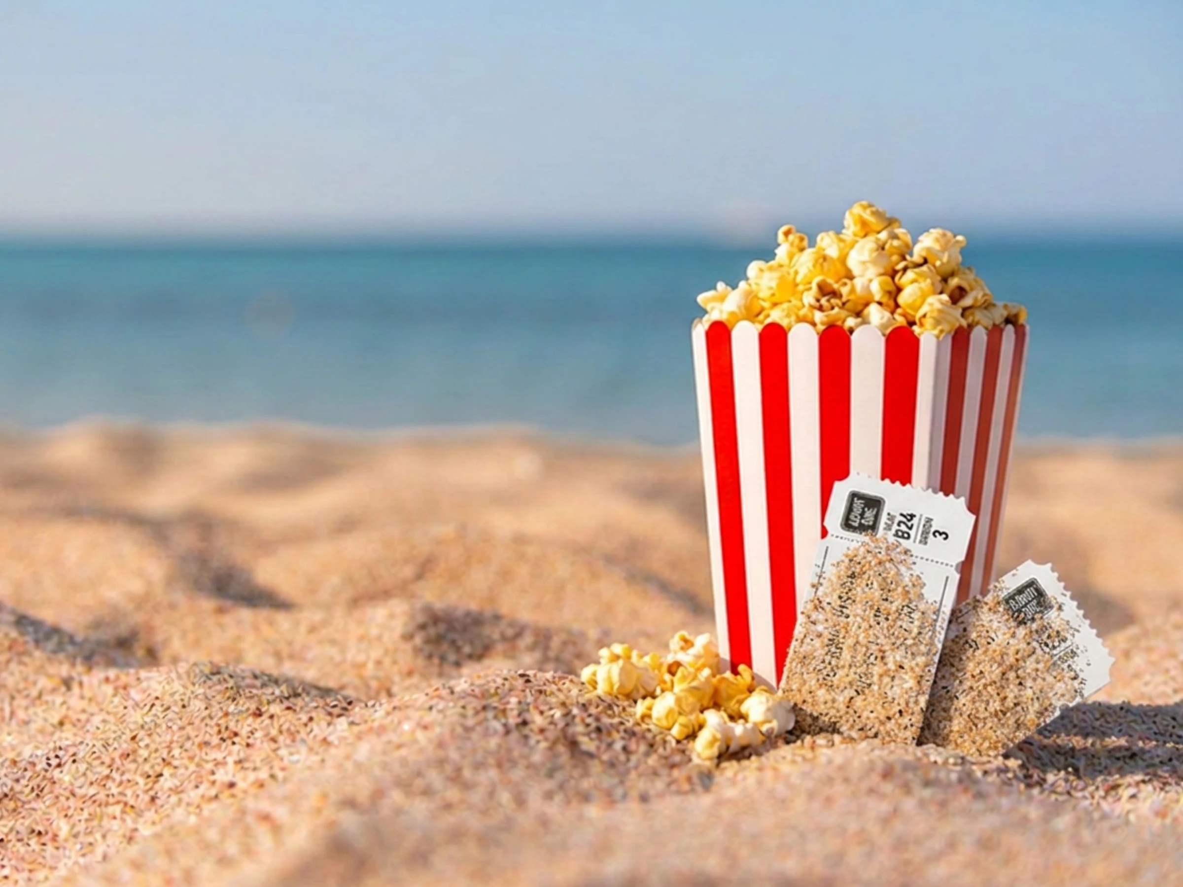 A bucket of popcorn on a sandy beach symbolises Britain