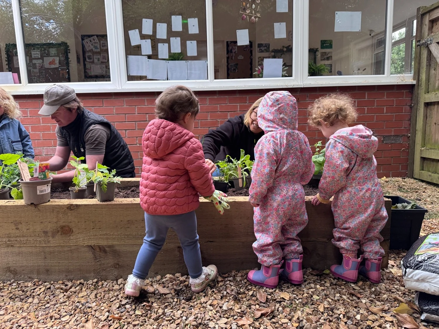 Sale nursery children learn about the joys of growing plants and herbs in new garden