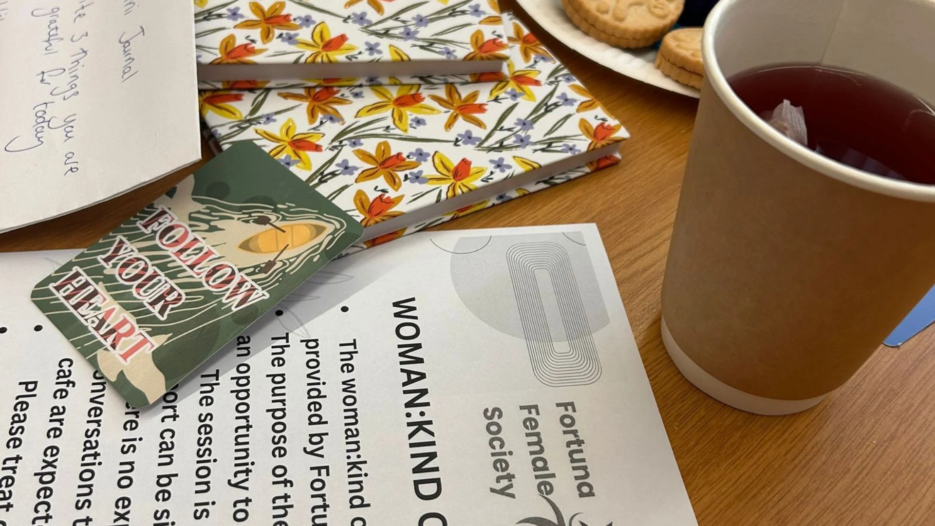 Photo of Woman:Kind Cafe table with inspiring quotes, session rules and a cup of tea